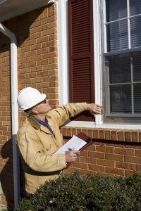 home inspector inspecting outside of the house