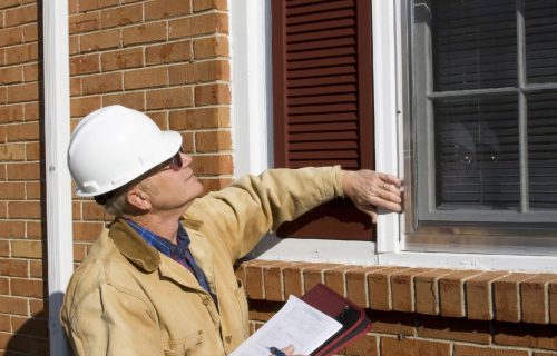 home inspector inspecting outside of the house